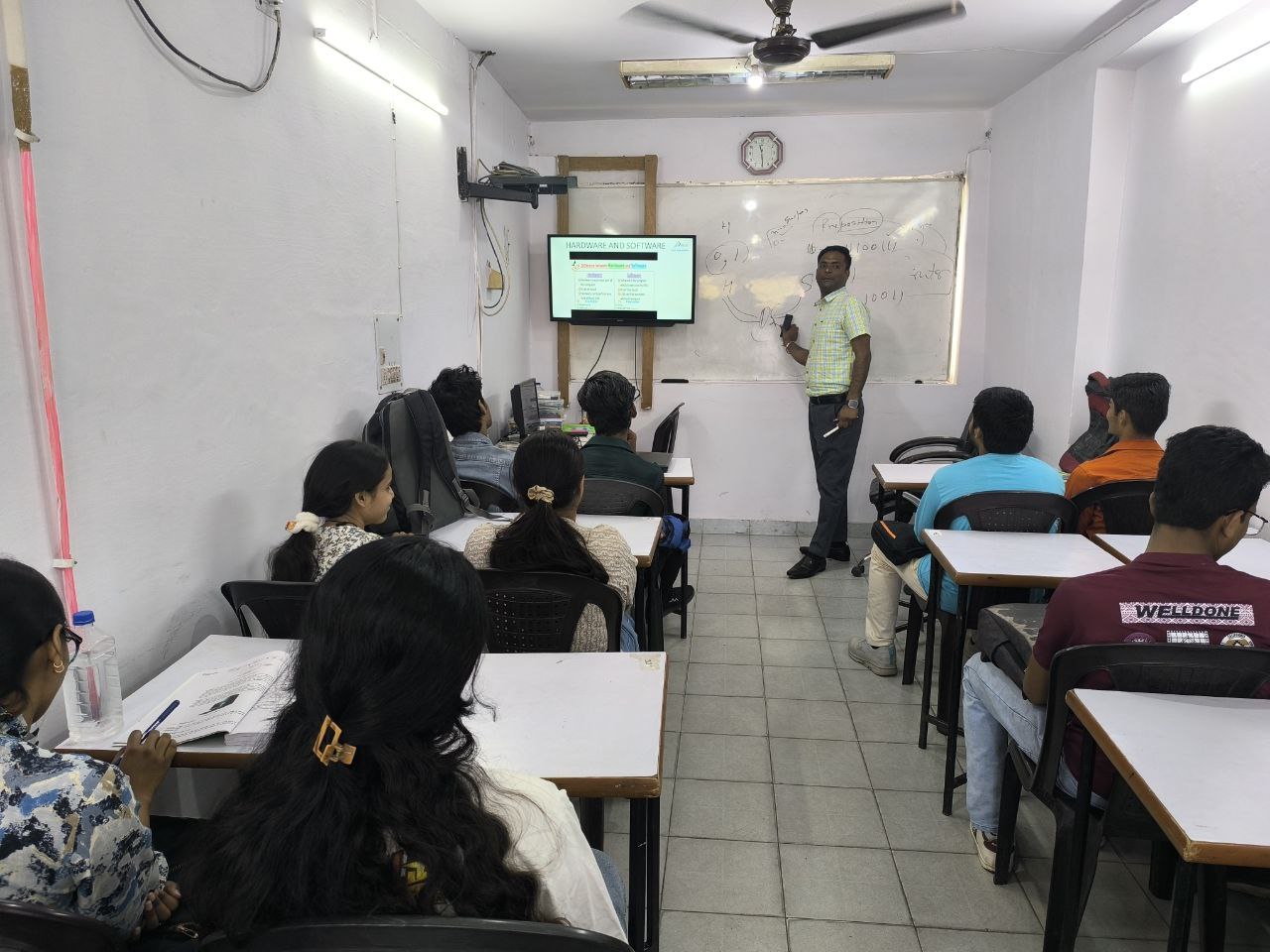 Instructor helping a student at a computer